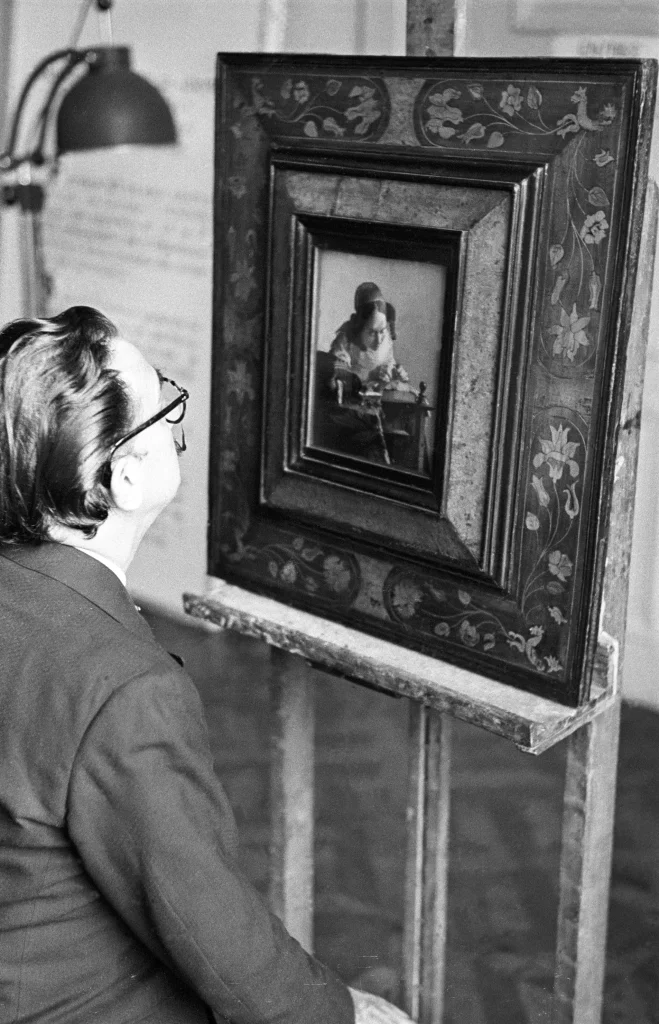 Salvador Dalí looking at Johannes Vermeer’s <em>The Lacemaker</em> (1669-1670) in the Louvre Museum in Paris, 1954 
Photo R. Descharnes/ © Descharnes & Descharnes sarl 2024 
Image rights of Salvador Dalí reserved. Fundació Gala-Salvador Dalí, Figueres, 2024